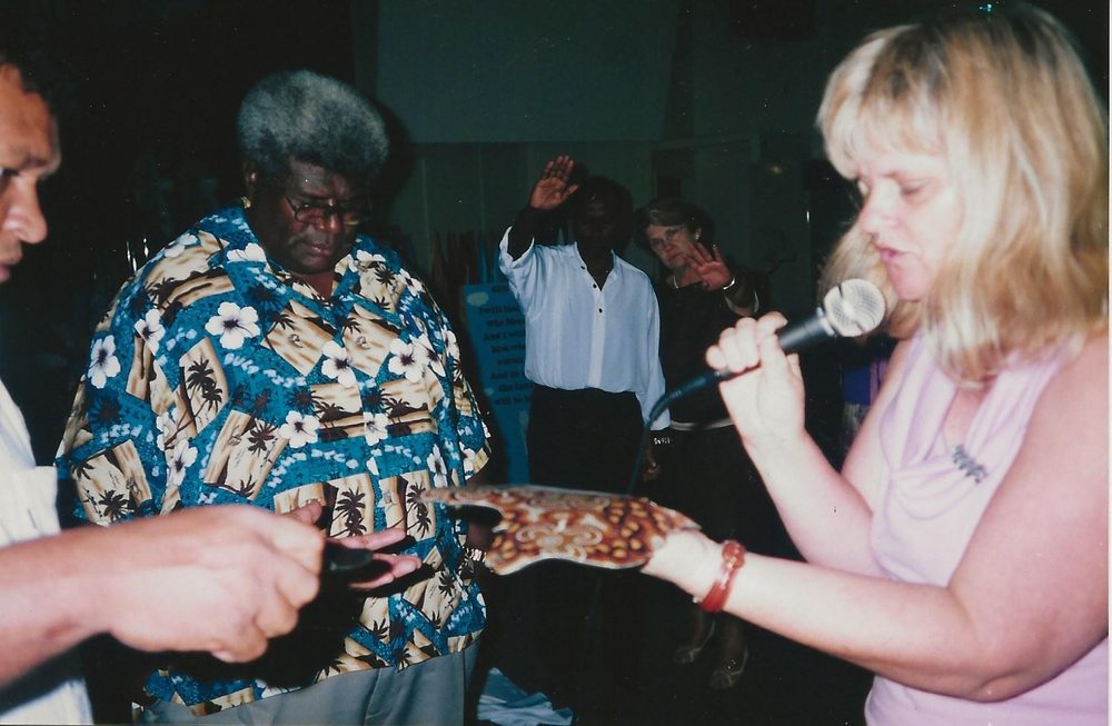 Healing the Land: Ps Barbara giving Ps Vuniani a map of Australia at our church in Cairns, 2003